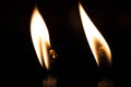 Closeup shot of burning candle lights in the darkness Royalty Free Stock Photo