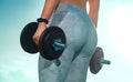 Closeup shot of butts with dumbbells. Athletic girl doing a fitness workout with weights. Woman working out with Royalty Free Stock Photo