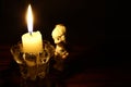 Closeup shot of a candlelight with an angel-shaped toy beside it