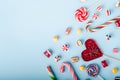 Closeup shot of candy canes and other candies on a light blue background
