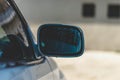 Closeup shot of a car mirror on a rainy day with blur background Royalty Free Stock Photo
