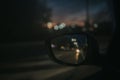 Closeup shot of a car's side mirror with reflection of the road Royalty Free Stock Photo