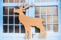 Closeup shot of a carved brown decorative deer on blue doors