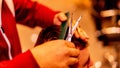 Closeup shot of a Caucasian barber cutting his client& x27;s hair.