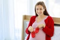Closeup shot of Caucasian millennial young female prenatal pregnant mother in casual pregnancy outfit jacket sitting smiling on Royalty Free Stock Photo