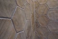 Closeup shot of a ceramic brown floor texture with patterns in the shape of honeycombs