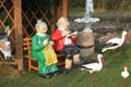 Closeup shot of ceramic figures of a senior couple and storks