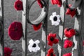 Closeup shot of a chain of knitted poppies on a fence
