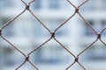 Closeup shot of a chain link fence with a blurry white background Royalty Free Stock Photo