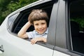 Cheerful Little Boy Looking Out Of Car Window While Having A Ride Royalty Free Stock Photo