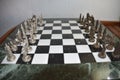 Closeup shot of a chess board with realistic silver and bronze pieces