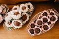 Closeup shot of chocolate candies with nuts in decorative flower buds Royalty Free Stock Photo