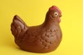 Closeup shot of a chocolate hen with a yellow background Royalty Free Stock Photo