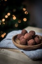 Closeup shot of chocolate round truffles in a wooden bowl on the table. Dessert wallpaper Royalty Free Stock Photo