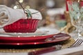 Closeup shot of Christmas dinner set up with glasses and ornaments on a table Royalty Free Stock Photo