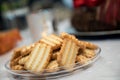 Closeup shot of Christmas Spritz cookies on a transparent plate