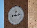 Closeup shot of the clock on the historic Torre del Mangia tower in Siena, Italy Royalty Free Stock Photo