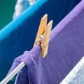 Closeup shot of clothes attached with a wooden pin on a clothesline