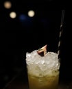 Closeup shot of a cocktail with ice and straw isolated on black background Royalty Free Stock Photo