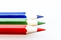 Closeup shot of 3 color pencils on a white surface Royalty Free Stock Photo