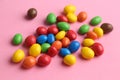 Closeup shot of colorful candy balls isolated scattered on a pink background Royalty Free Stock Photo