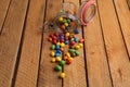 Closeup shot of colorful coated chocolate candies on a wooden table