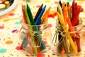 Closeup shot of colorful crayons in glass jars Royalty Free Stock Photo