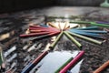 Closeup shot of colorful crayons stacked on the wet ground symbolizing rainbow Royalty Free Stock Photo