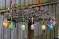Closeup shot of colorful Easter eggs hanging on a bird nest Royalty Free Stock Photo