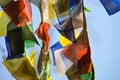 Closeup shot of colorful festival flags on a blue sky background Royalty Free Stock Photo