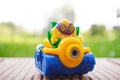 Closeup shot of a colorful figurine toy sitting on a wooden surface