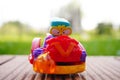 Closeup shot of a colorful figurine toy sitting on a wooden surface