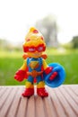 Closeup shot of a colorful figurine toy sitting on a wooden surface