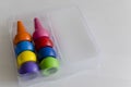 Closeup shot of colorful finger crayons on a white surface Royalty Free Stock Photo