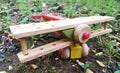 Closeup shot of a colorful handmade wooden helicopter outdoors on the ground of the garden