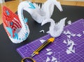 Closeup shot of colorful origami swans on a black desk