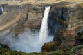 Closeup shot of the colorful and textured volcanic rocks with Haifoss waterfall next to it. Porsadalur valley area in Iceland. Royalty Free Stock Photo