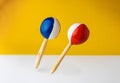 Closeup shot of colorful wooden maracas in the color background