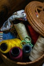 Closeup shot of colorful yarn rolls in a woven basket Royalty Free Stock Photo