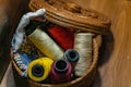 Closeup shot of colorful yarn rolls in a woven basket Royalty Free Stock Photo