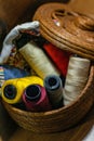 Closeup shot of colorful yarn rolls in a woven basket Royalty Free Stock Photo