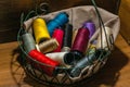 Closeup shot of colorful yarn rolls in a woven basket Royalty Free Stock Photo