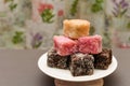 Closeup shot of colourful Australian dessert Lamingtons stacked and served on a cake stand