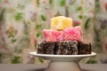 Closeup shot of colourful Australian dessert Lamingtons stacked and served on a cake stand