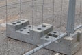 Closeup shot of a concrete stand and a wire fence attached to it