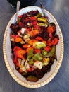 Closeup shot of cooking vegetable stew from a mixture of different vegetables in a pan.