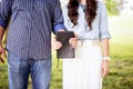 Closeup shot of couple both holding the bible with a blurred background Royalty Free Stock Photo