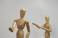 Closeup shot of a couple of drawing art figurines depicting a complicated relationship