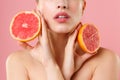 Close up shot cropped blonde half naked woman 20s perfect skin nude make up hold in hand grapefruit isolated on pastel Royalty Free Stock Photo