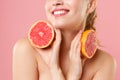 Close up shot cropped blonde half naked woman 20s perfect skin nude make up hold in hand grapefruit isolated on pastel Royalty Free Stock Photo